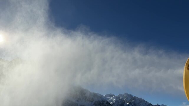 Passo del Tonale, Italy. Snow cannon. Snowmaker in action at ski resort spraying artificial snow. Winter contest. Alps