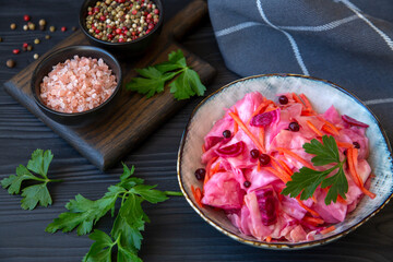 Sauerkraut in a bowl on a wooden table. Healthy fermented food rich in vitamins, antioxidants, fiber.