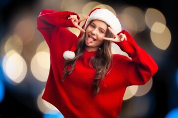 Beautiful santa girl in christmas hat on background