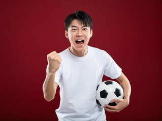 Asian man cheering football game expressing excitement