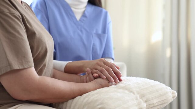 Smiling nurse sharing joyful moment with elderly woman during home caregiving session, expressing empathy, laughter, and companionship that promote mental wellness, recovery, and positive relationship