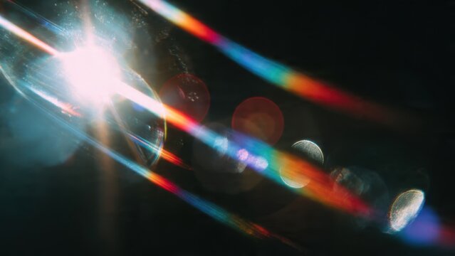 Intense analog lens flare effect with vibrant rainbow spectral streaks and bright light source anomaly, perfect cinematic overlay texture on dark background.