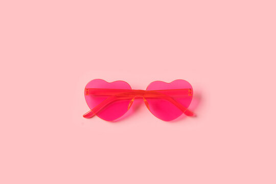 Bright pink heart shape glasses close up