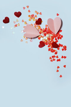 Bright pink heart confetti and paper heart close up