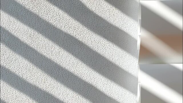 Sunlight creating striped shadows and abstract patterns a textured with wall window white blinds video 4k