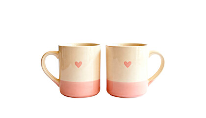 Two matching ceramic coffee mugs with small heart prints, perfect for a couple's breakfast, isolated on white