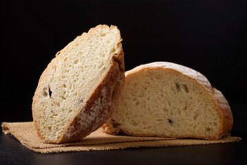 Freshly baked sourdough bread   on a black background