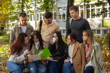 Large group of university students studying and socializing outdoors