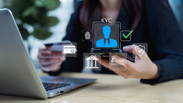 Businesswoman using an interactive digital KYC interface performs E-KYC verification and ensures compliance with security requirements for using banking apps and credit card usage for shopping. - Powered by Adobe