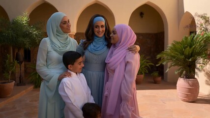 A gathering of family and friends embraces within the walls of a traditional building Stock Video