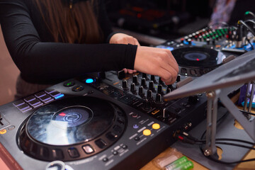 DJ setup overview, Energetic club DJ performing with digital controller in action, Content creator mixing music live using digital turntables under vibrant stage lights