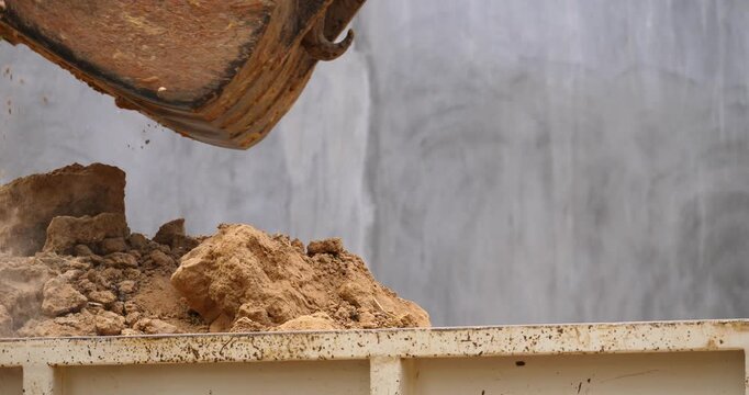 Backhoe excavator digging soil at construction site, backhoe digging soil for trucks