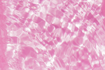 Fototapeta premium Close-up of calm pink clear water surface with water spray and bubbles. Trendy abstract summer nature background. Coral waves in sunlight