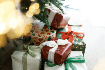 Christmas presents. Stylish christmas gift boxes with festive ribbons and ornaments under christmas...