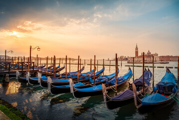 Traditional gondolas anchored on the Grand Canal in Venice, Italy. © Balate Dorin