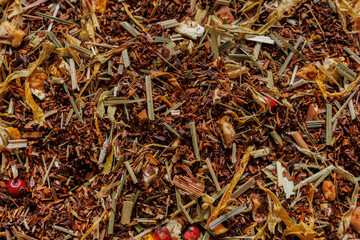 Herbal rooibos tea blend with dried herbs and spices close up © Iryna Miadzvedzeva
