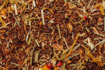 Herbal rooibos loose leaf tea with orange peel and dried berries close up