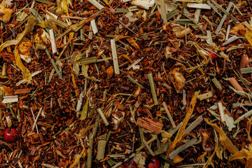Herbal rooibos loose leaf tea with orange peel and dried berries close up