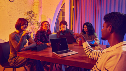 Team listening to colleague presenting ideas during group discussion. Concept of teamwork, communication flow, creative thinking, startup collaboration, and shared decision-making.