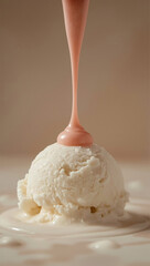 Vanilla ice cream with thick pink syrup pouring on top. It looks smooth, sweet, and creamy