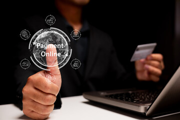 A person is showing a thumbs-up while holding a credit card, with a digital overlay indicating "Payment Online" beside a laptop.