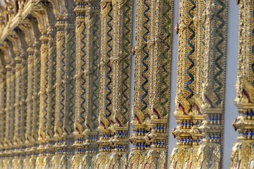 Columns with mosaic decorations (Lai Kranok), also: golden, mosaic-decorated Thai temple columns (Sao), decorated in the Lai Kranok style, typical of Rattanakosin architecture (Bangkok style), on the outer façade of the Ubosot (ordination hall), Wat Chana Songkhram, Phra Nakhon, Bangkok, Thailand