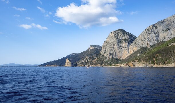 Picturesque rocky coast, cliffs with Pedra Longa pinnacle, blue sea, Golfo di Orosei, Baunei, Sardinia, Italy