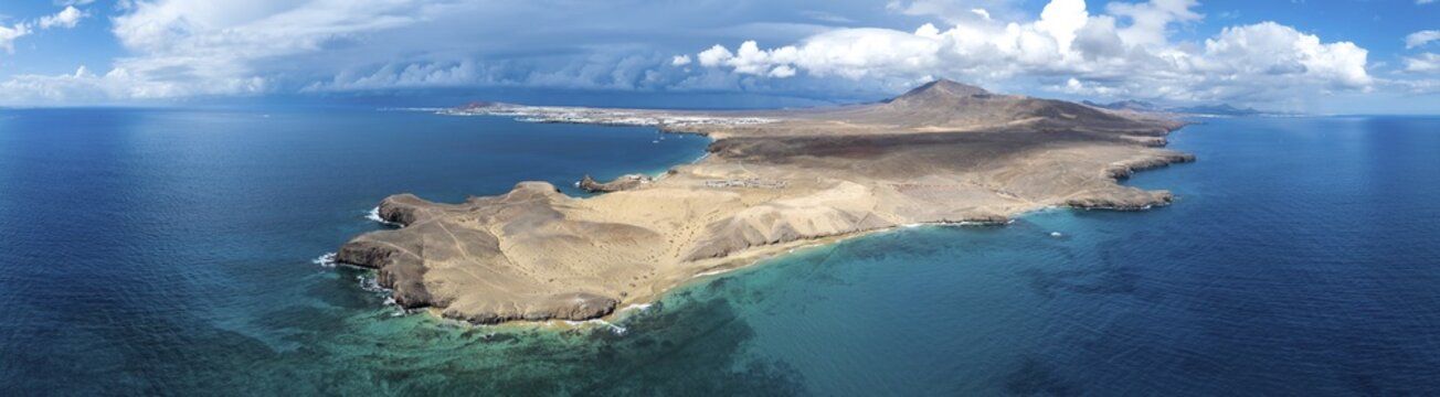 Headland and blue sea, coastal landscape, arid landscape of Los Ajaches Natural Park, aerial view, Lanzarote, Canary Islands, Spain