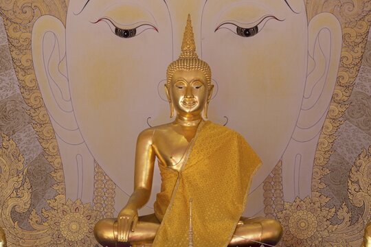 Golden Buddha statue with tunic, Bhumispara mudra, Buddha Gautama at the moment of enlightenment, art hall with exhibition of non-traditional works of art, most of which follow modern art trends such as minimalism and abstraction, Wat Sitthawararam, Bangkok, Thailand