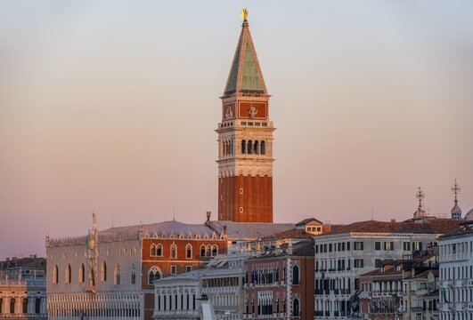 Campanile bell tower and Doge's Palace at sunrise, waterfront promenade, Venice, Veneto, Italy