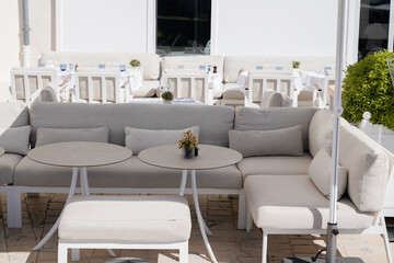 outdoor lounge dining area in natural light table and chairs in a restaurant