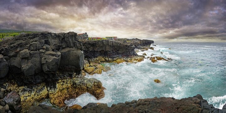 View of the wild coastline with rugged cliffs of lava rock and roaring waves under a grey sky, North Coast, Santa Luzia, Pico, Azores, Portugal
