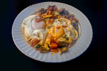 Breakfast with tomatoes, peppers and eggs.