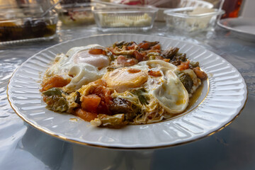 Breakfast with tomatoes, peppers and eggs.