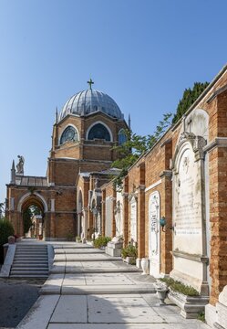 Graves on a wall, behind the dome of St Christopher's Church, San Michele cemetery island, Venice, Italy
