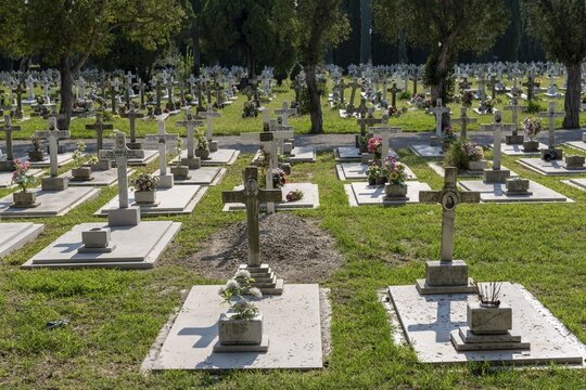 Row of graves with crosses, San Michele cemetery island, Venice, Italy