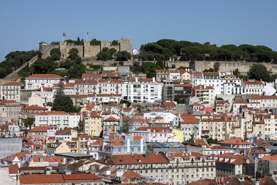View from the Miradouro de Sao Pedro over the historic centre of Lisbon, with Castelo de Sao Jorge in the background, Lisbon, Portugal