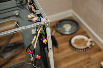 Disassembled washing machine with exposed parts during repair, showing appliance diagnostics.