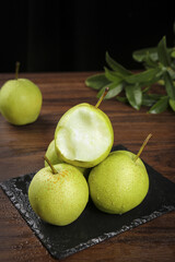 Fresh Green Pears with Crisp Skin on Slate Board
