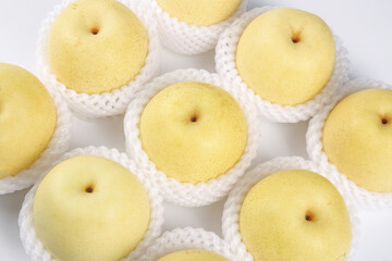 Fresh Yellow Pears in Protective Mesh Packaging - Studio Still Life