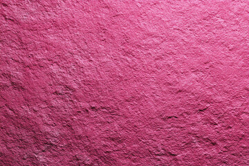 Close up of a rough textured pink slate surface