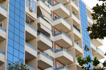 Mediterranean city building in Albania, pale exterior and structured terraces. Suitable for property rentals, real estate sales, relocation plans, and holiday apartment searches.