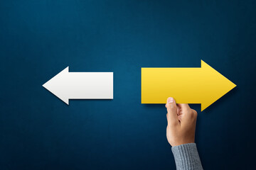 A man choose arrow pointing opposite with arrows white as a symbol of think different, new idea, unique lead and innovative solution