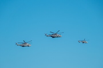 Portsmuth England - November 30 2025: A wildcat and two merlin helicopters flypast to welcome home the Carrier Strike Group 25 CSG 25 deployment Operation Highmast