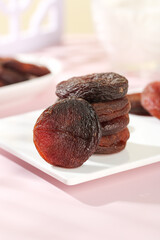 Dried Candied Apricots from Xinjiang China on White Plate - Traditional Preserved Fruit Snack