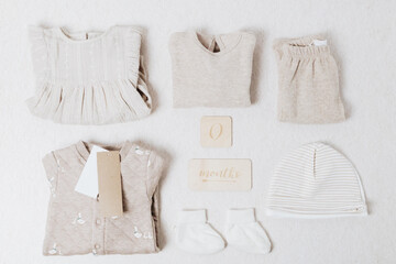 Delicate beige and cream clothing sets for newborns.