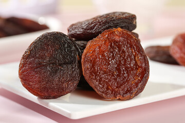 Dried Candied Apricots from Xinjiang China on White Plate - Nutless Fruit Snack Food Photography