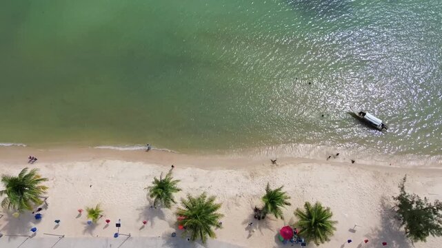 Aerial view of turquoise tropical waters with boats and huts on New Melur beach, Batam City, Riau Islands, Indonesia