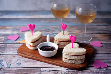 Sandwiches with berries jam in the form of hearts for Valentine's day holidays