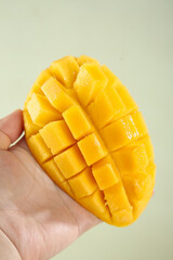 Fresh Cut Mango Cubes in Hand - Ripe Tropical Fruit Ready to Eat